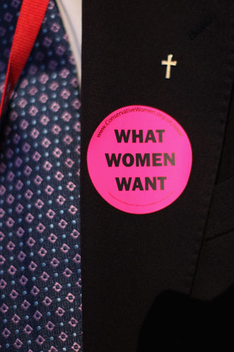 Conservative conference 2: A man wears a sticker saying 'What Women Want' 