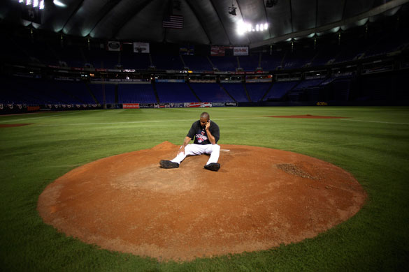 24sport: Delmon Young makes a mobile phone call as he sits on the mound