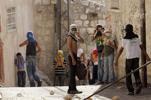 7 October 2009: Jerusalem: Palestinian youths look out for Israeli border police