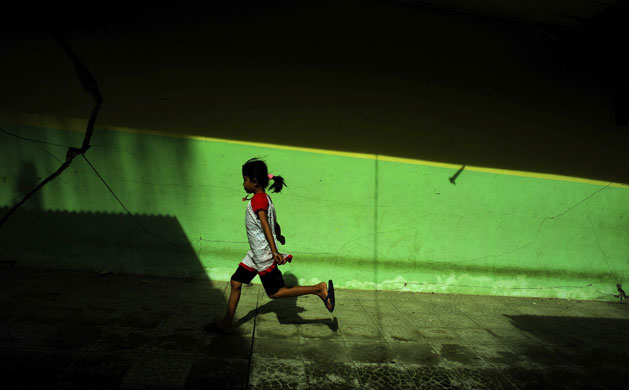 7 October 2009: Padang, Sumatra: Cracks are visible as a girl runs through a primary school