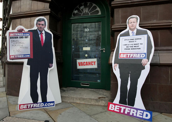 Conservative conference 3: Cut outs of Gordon Brown and David Cameron outside BetFred Bookmakers