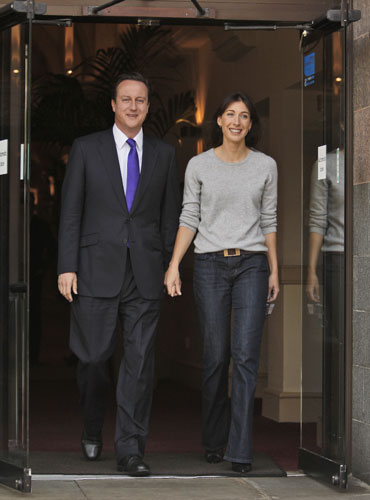 Conservative conference 3: Party leader David Cameron leaves the Midland Hotel with his wife Samantha