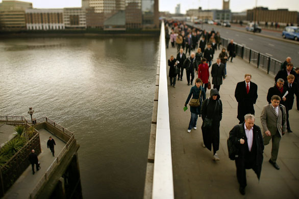 Week in business: Commuters walk over London Bridge towards the City of London