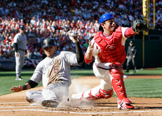 24sport: Colorado Rockies' Carlos Gonzalez slides safely into home plate to score 