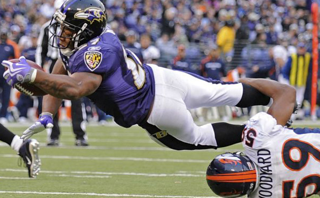 Baltimore Ravens running back Ray Rice leaps into the endzone for a touchdown as Denver Broncos linebacker Wesley Woodyard attempts to tackle him 