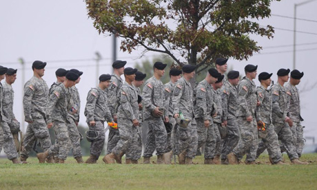Soldiers walk on the grounds of Fort Hood army base in Texas. Thirteen people were killed in a shooting at the base last week. Photograph: Tannen Maury/EPA