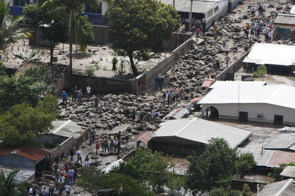 El Salvador hurricane: People stand in an area affected by flooding and mudslides in Verapaz