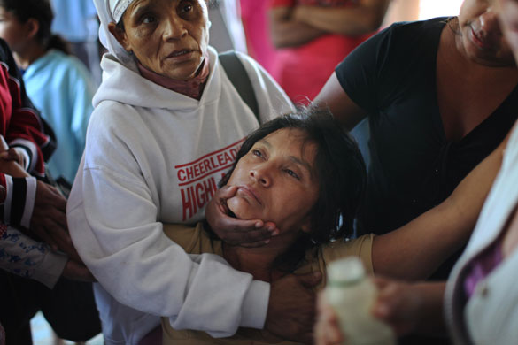 El Salvador hurricane: Margarita Castillo is held as she grieves for her sister 