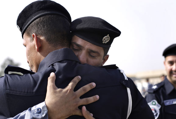 24 hours: Baghdad, Iraq: Newly graduated police officers embrace