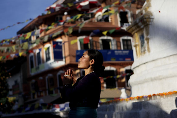 24 hours: Katmandu, Nepal: An exiled Tibetan Buddhist woman prays