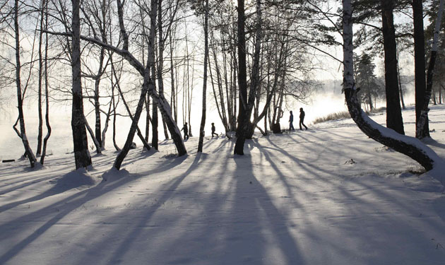 24 hours: People walk along the bank of the Yenisey River in Siberia