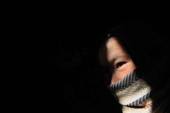 24 hours: Bamiyan, Afghanistan: A Hazara  woman sits in her cave