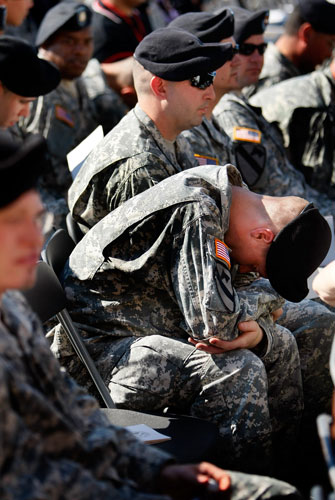 Obama visits Fort Hood: Army soldiers sit together as they wait for the start of a memorial service