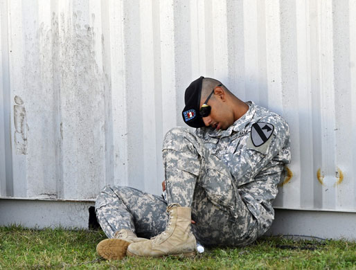 Obama visits Fort Hood: A soldier sleeps while waiting for the memorial service
