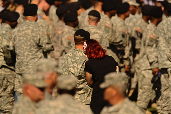 Obama visits Fort Hood: A soldier and an unidentified woman wait for the memorial service