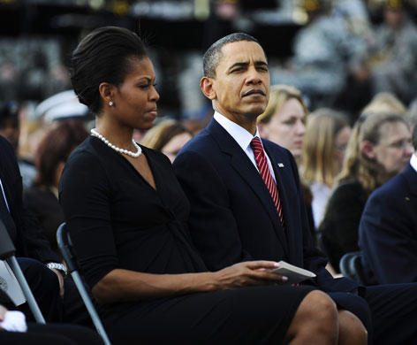 Obama visits Fort Hood: Barack Obama sits with his wife during the memorial service