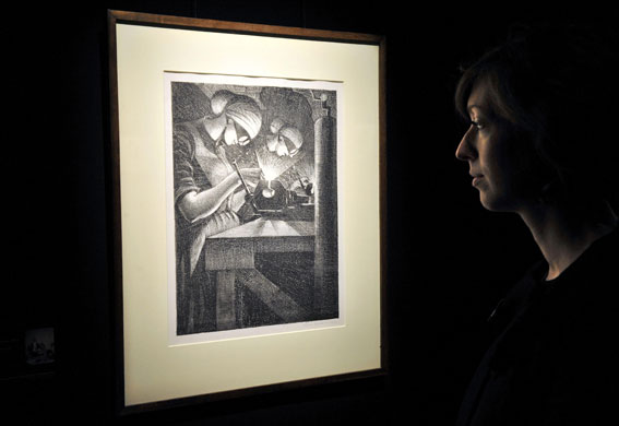 Lord Attenborough auction: A woman views CRW Nevinson's Building Aircraft: Acetylene Welder