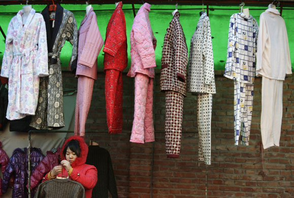 24 hours: Beijing, China: A vendor sells pyjamas at a market