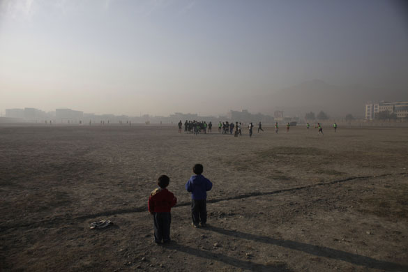 24 hours in pictures:  Kabul, Afghanistan: Two children watch a football match