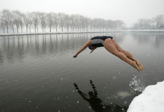 24 hours in pictures: A winter swimmer jumps into icy water at a park in Shenyang