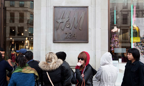 Shoppers wait outside H&M on Regent Street
