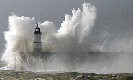 Huge waves break over the lighthouse on Newhaven harbour