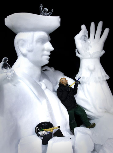 24 Hours in Pix: A sculptor carves the finishing touches to his ice sculpture 