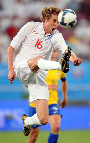 Brazil v England: Peter Crouch leaps to control the ball 