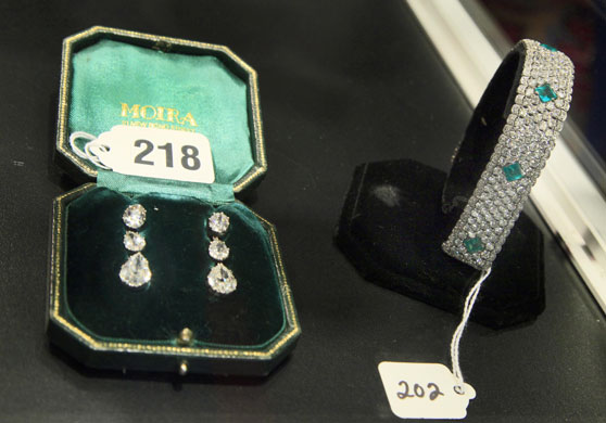 Madoff auction: Silver diamond earrings and a platinum diamond & emerald link bracelet
