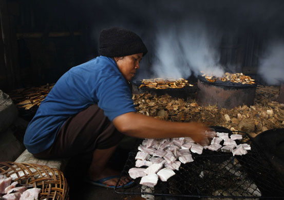 15 November 2009: Semarang, Indonesia: A woman at a smoked fish processing compound