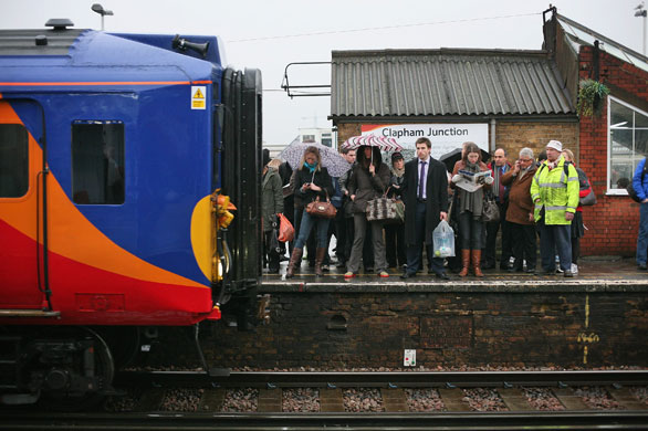 Train stations: Commuters wait to squeeze on to the next train  at Clapham Junction