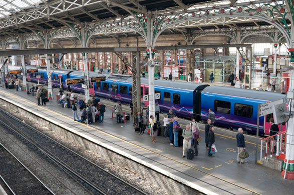Train stations: Passengers on a platform at Preston railway station, Lancashire