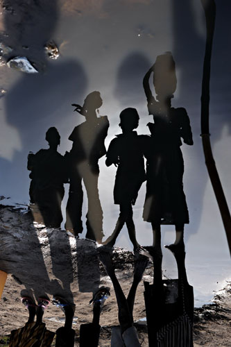 17 November 2009: Guit, Sudan: A 180 degrees rotated photo of women and children