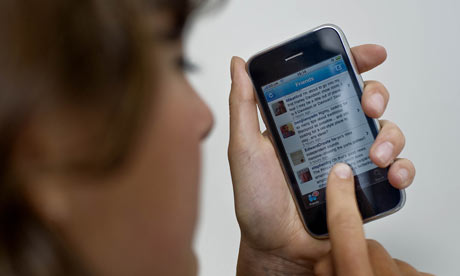 Woman checks Twitter website on iPhone