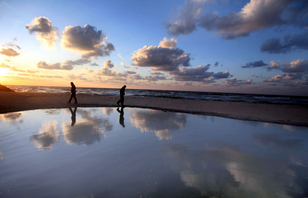 24 hours in pictures: A Palestinian man walks on the shore of mediterranean in Gaza