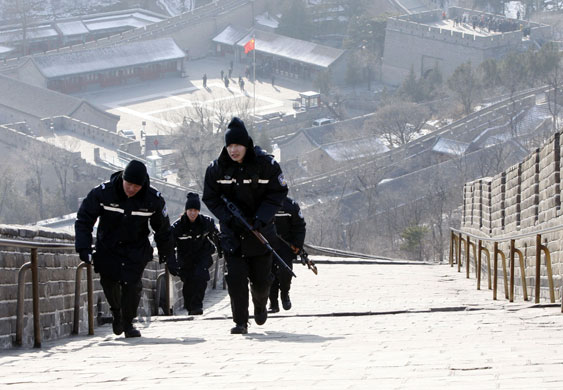Obama in Asia: Police walk up the Great Wall of China before President Obama arrives