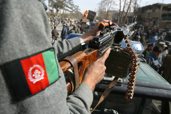 Hamid Karzai: A policeman secures Herat city