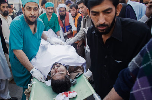 Pakistan bombing: Doctors and emergency crew rush a victim in for emergency treatment