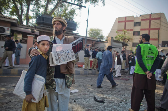 Pakistan bombing: A man and his son survey the site