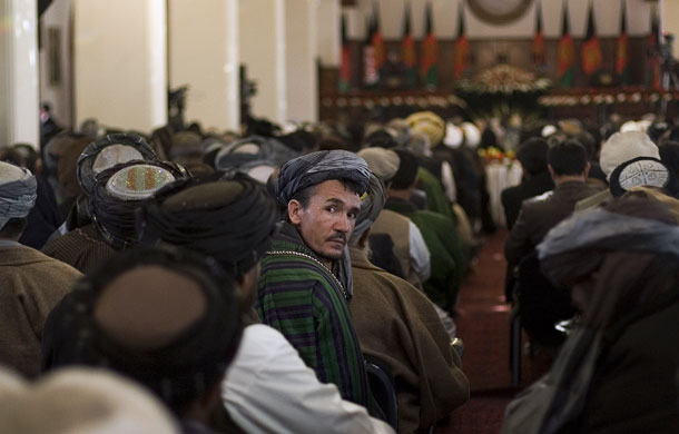 hamid karzai: A man follows Hamid Karzai's inauguration ceremony