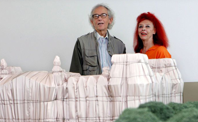 Christo and his wife Jeanne-Claude stand in front of a model of their work titled Wrapped Reichstag at the Wuerth Museum in La Rioja, Spain