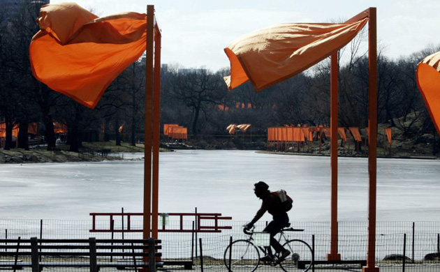 A bicyclist rides through  Christo and Jeanne-Claude's The Gates at New York's Central Park in 2005