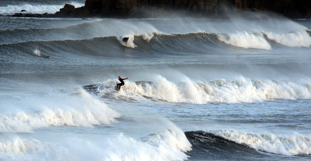 wet weather uk: Surfer at Tynemouth, North Tyneside