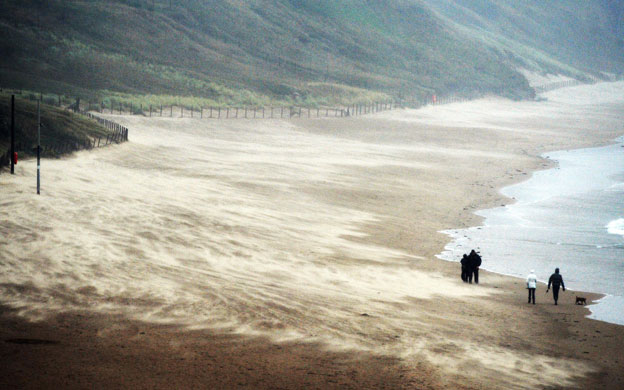 wet weather uk: Sand is blown across the beach at Tynemouth