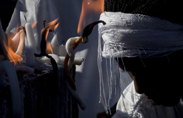 24 hours in pictures: Port-au-Prince, Haiti: A woman takes part in a Voodoo ritual during
