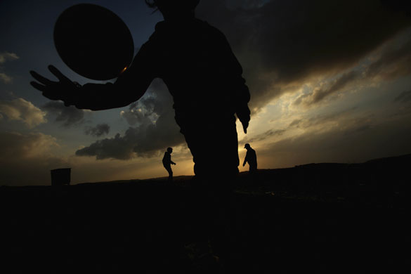 24 hours in pictures: Ramallah, West Bank: Palestinian children play football in the street