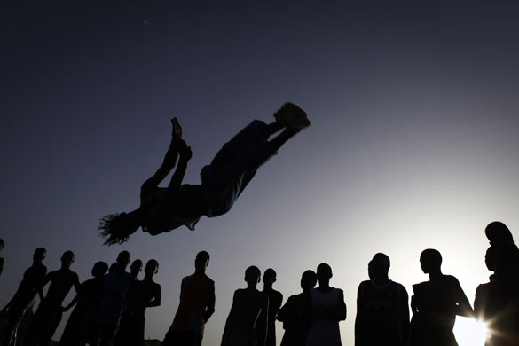 24 hours in pictures: People watch as an acrobat practices in Senegal 