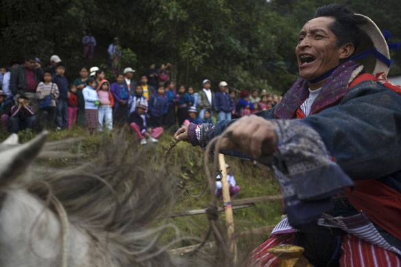 24 hours in pictures: A rider takes part in a horse race on All Saints Day in Todos Santos