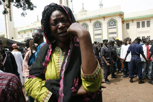 Guinea unrest: A woman cries after identifying the body of a relative killed at a rally