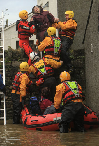 Weather flooding: Firefighters and RNLI personnel rescue Pat Edwards in Cockermouth